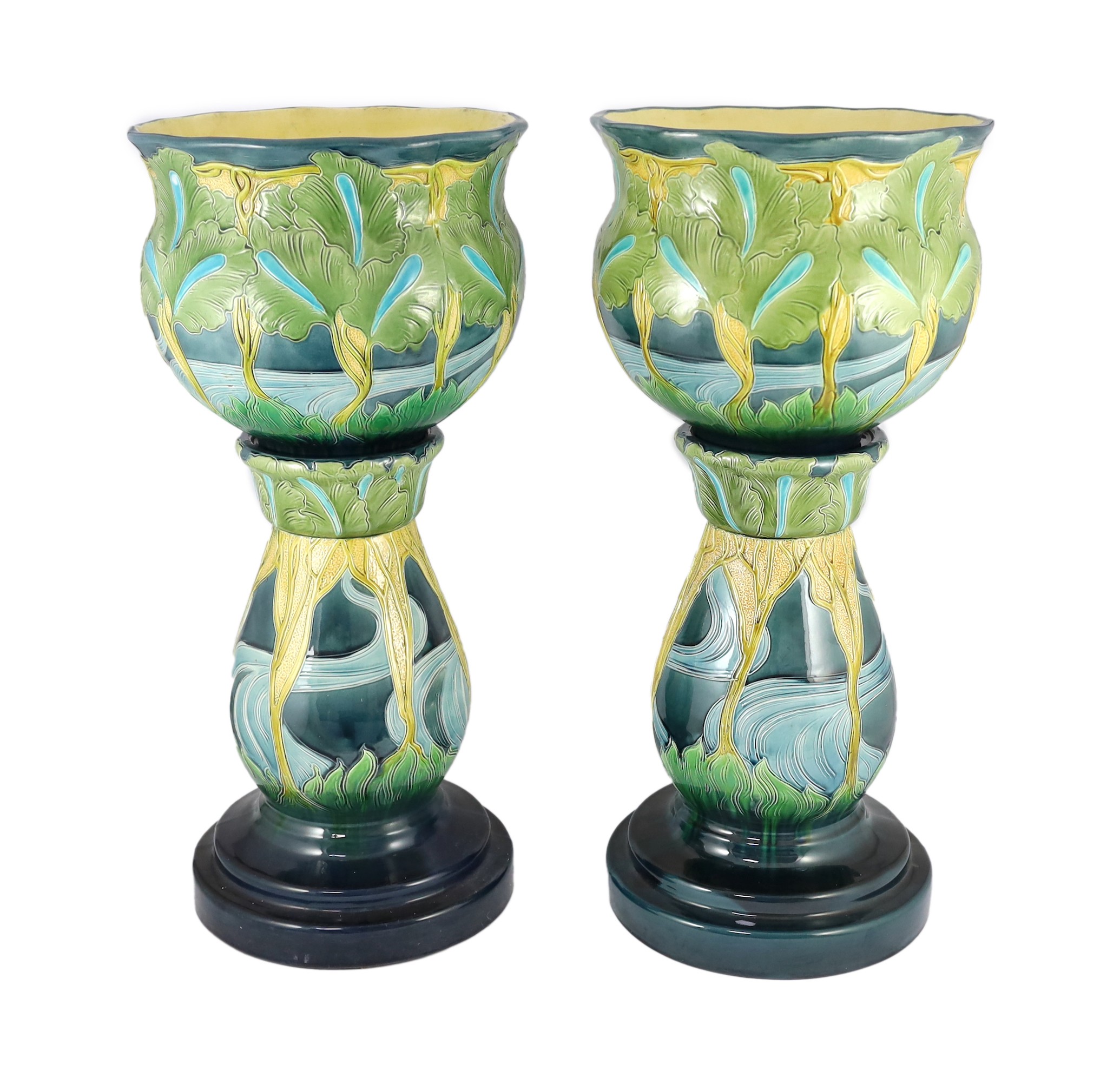 A pair of Burmantofts Art Nouveau faience jardinieres on matching pedestals, c.1900, total height 69cm, diameter 32cm, minor faults